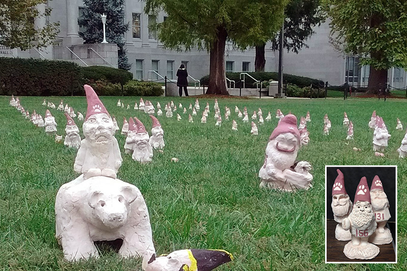 Ceramic figurines of gnomes on campus lawn