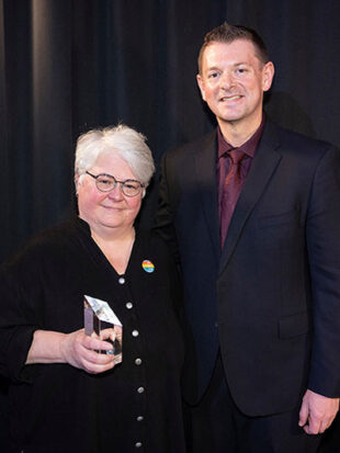 Man and woman at an awards ceremony