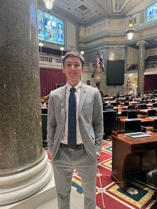 Young man in suit standing in state legislation room