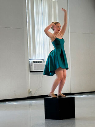 Young woman dancing on small platform
