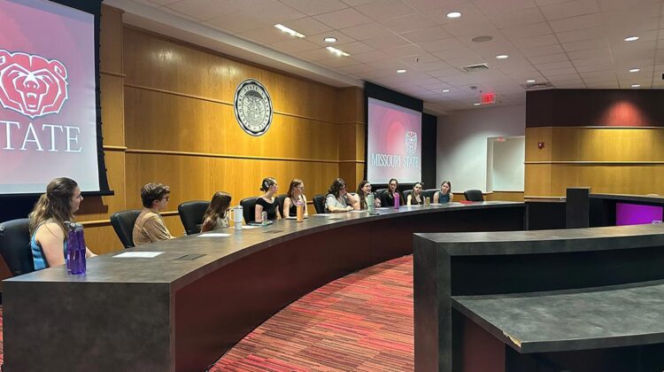 Students sitting at conference table