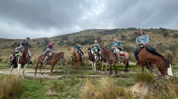 Individuals on horseback against South American mountain landscape