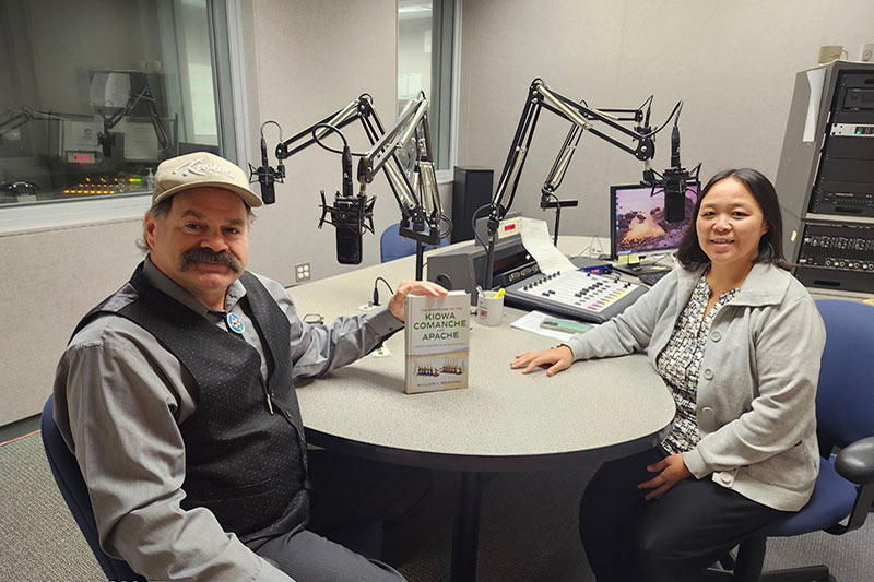 Man and woman sitting in radio booth