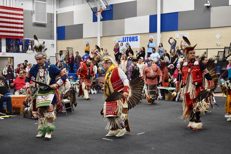 Group of people playing a Native American handgame
