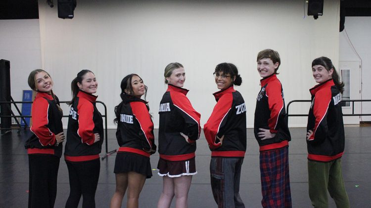 Seven young adults standing in a line