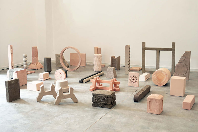 Various ceramic artwork items displayed on floor