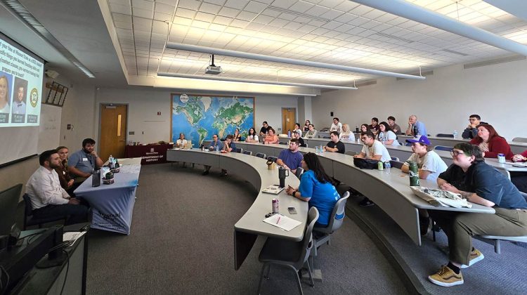 Group of people in classroom listening to speakers