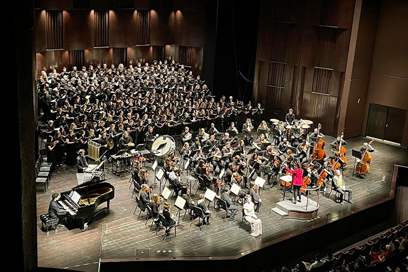 Overhead photo of orchestra and chorus performing on stage