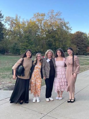 Five women standing outside