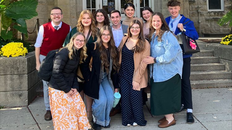 Group of young people standing outside in front of building