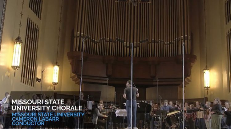 Film still depicting a choir singing