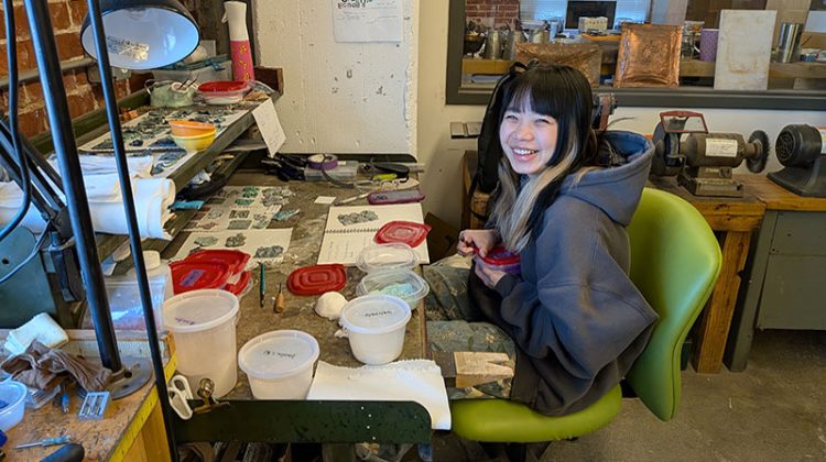 Young woman in art studio laughing