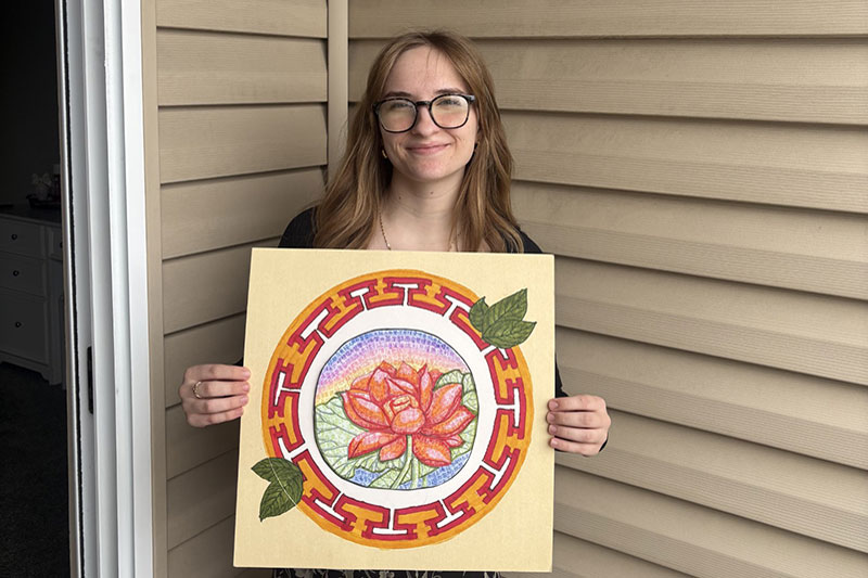 Young woman holding Chinese artwork