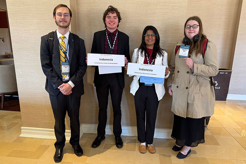 Students standing with delegation placards