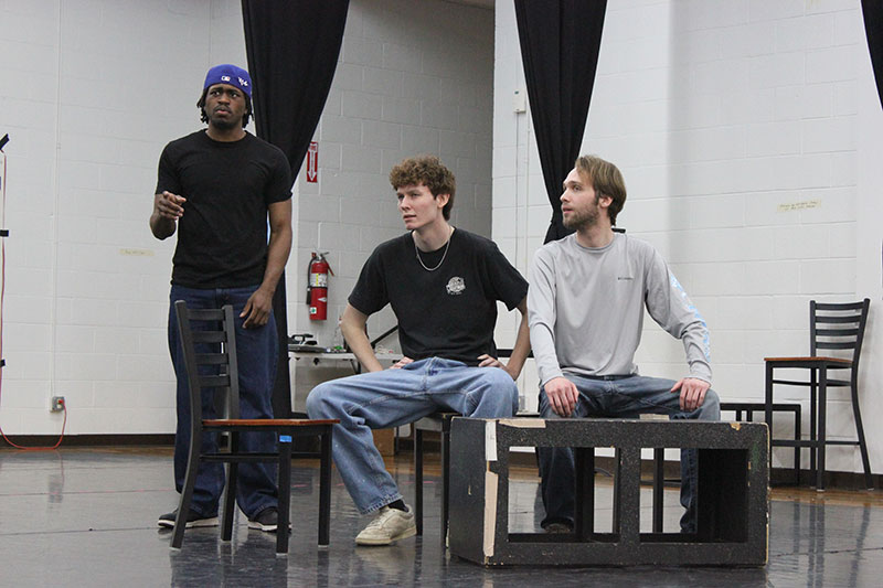 Three college actors performing during a rehearsal