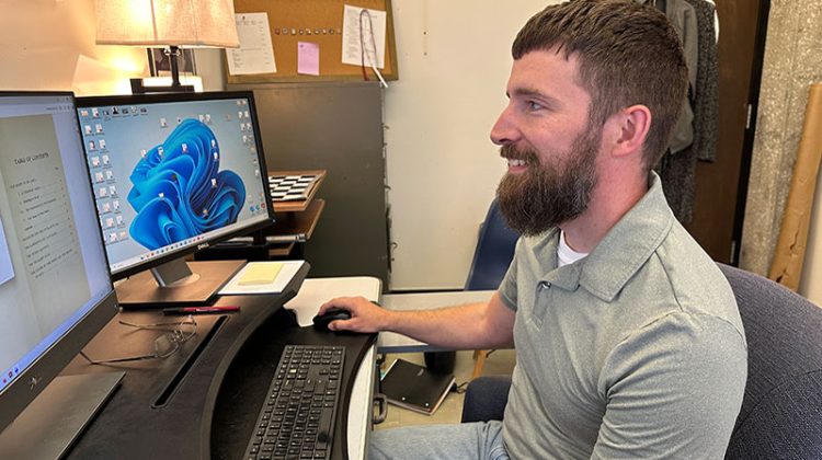 Man sitting at desk looking at computer