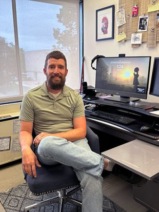 Man sitting in front of desk and computer