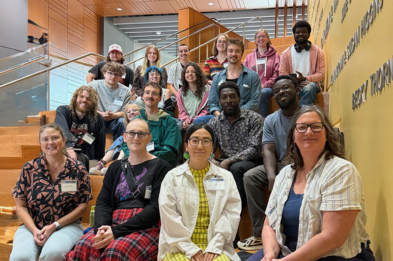 Group of people sitting on indoor steps