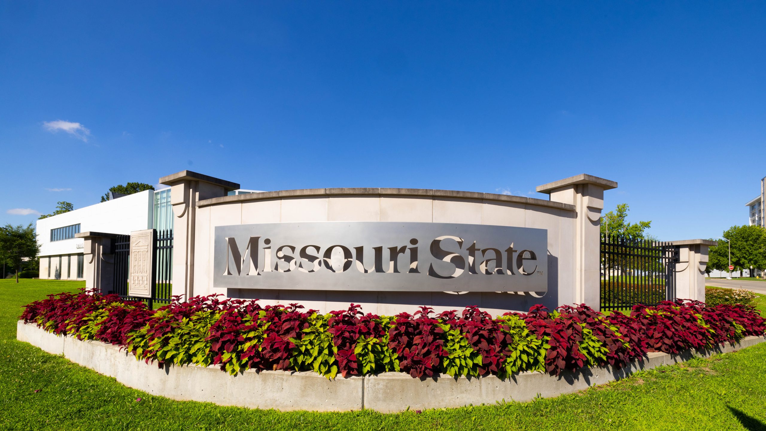 Entrance to the university in the summer, sign reads Missouri State