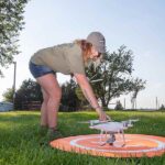 Bailey Wolf prepping drone for takeoff.