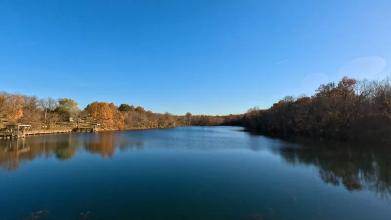 Photo of a tranquil waterway with trees on each side