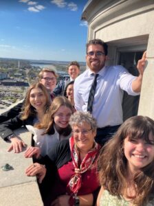Dr. Suzanne Walker-Pacheco and Paws to the Poles members basking in the sun on the roof of the Missouri Capital building