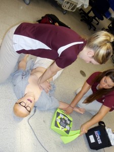 Kristin Tivener with SMAT alunmi, Abby Eckert performing CPR on a high-fidelity simulation mannequin.