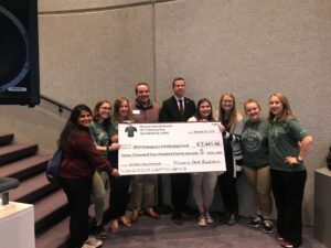 Missouri State Bookstore presents Check to the Student Alumni Association for the proceeds of the Be A Bear Shirt