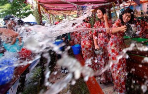 Ethnic Rakhine girls play with water as they celebrate Thingyan, Myanmar's new year water festival, in central Yangon