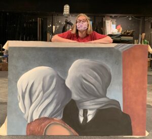 Riley Lathrom with her painting of "The Lovers II," originally painted by Rene Magritte