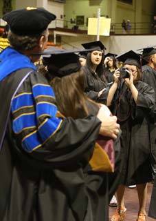 Professor takes photo with graduate
