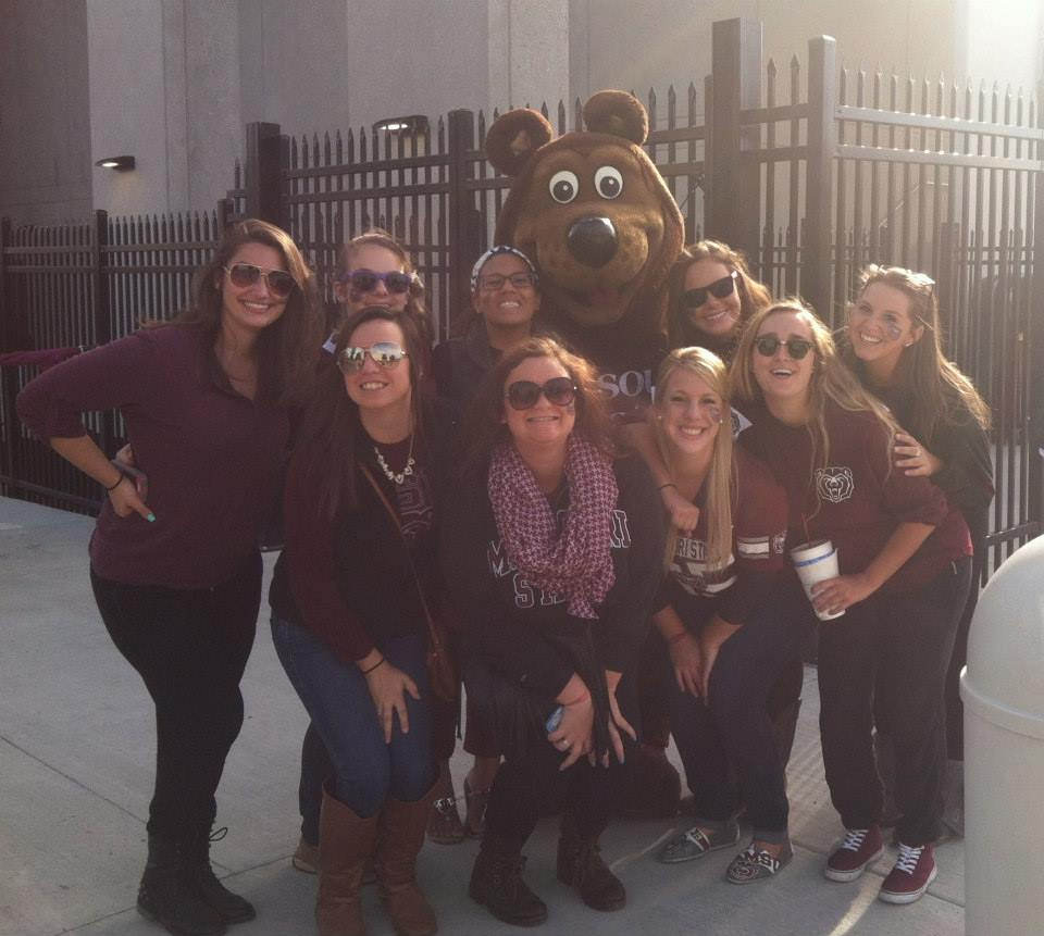 Friends pose with Boomer in front of Plaster Stadium