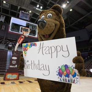 Boomer with happy birthday sign in gym