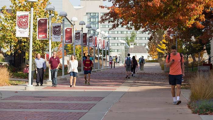 wideshot of people walking on campus