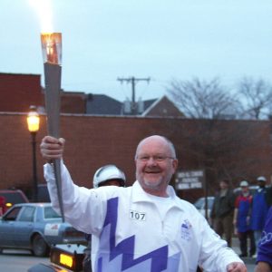 Peter Herschend carrying torch