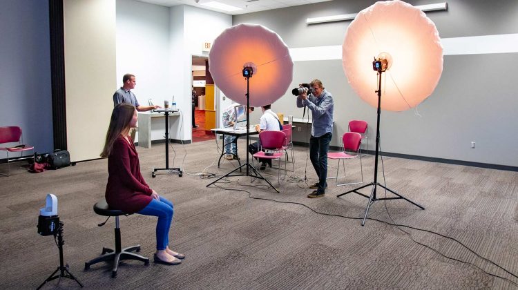 Missouri State University employee having photo taken during free staff and faculty portrait days event.