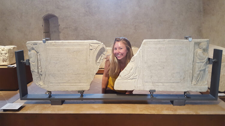 Dr. Kristin Harper with a Roman inscription (Photo Credit: Dr. Kristin Harper)