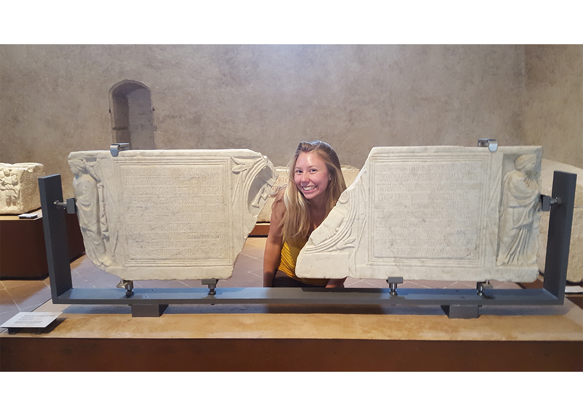 Dr. Kristin Harper with a Roman inscription (Photo Credit: Dr. Kristin Harper)