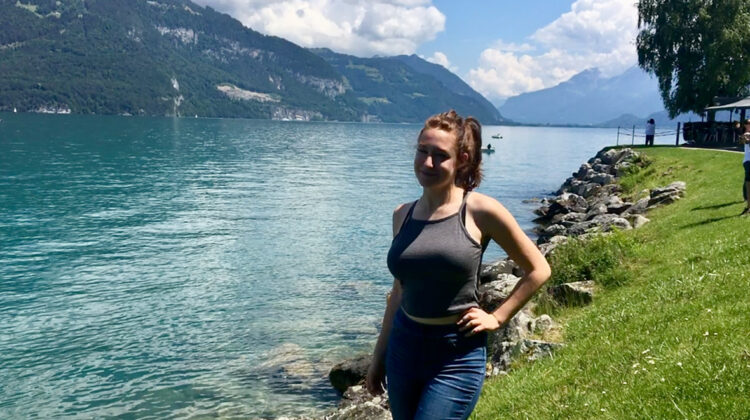 Abigail Goertzen standing in front of a river and mountain (Photo credit: Abigail Goertzen)