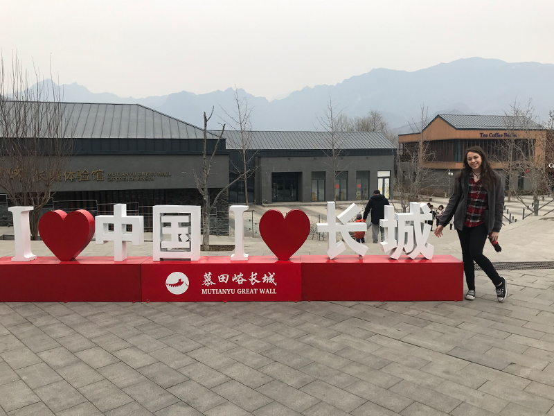 Photo of Samantha Tintner with a statue reading "I love China I love the great wall" (Photo Credit: Samantha Tintner)