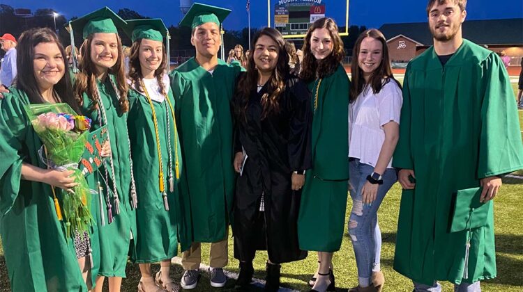 Photo of Catalina Silva with a group of students in graduation gowns (Photo Credit: Catalina Silva)