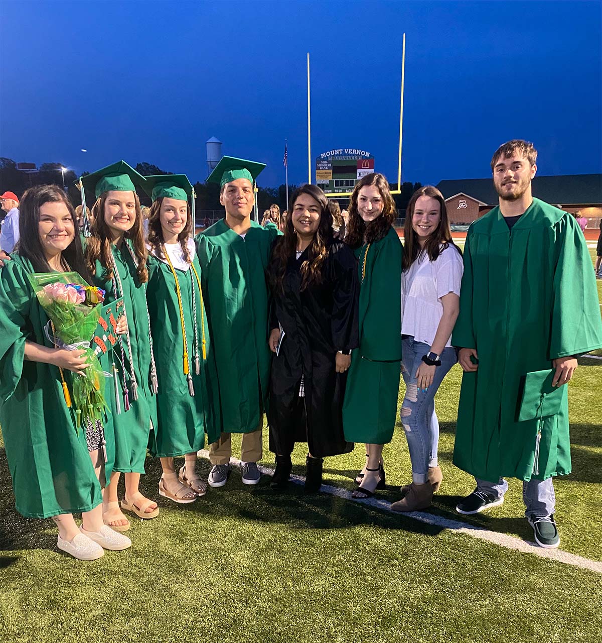 Photo of Catalina Silva with a group of students in graduation gowns (Photo Credit: Catalina Silva)