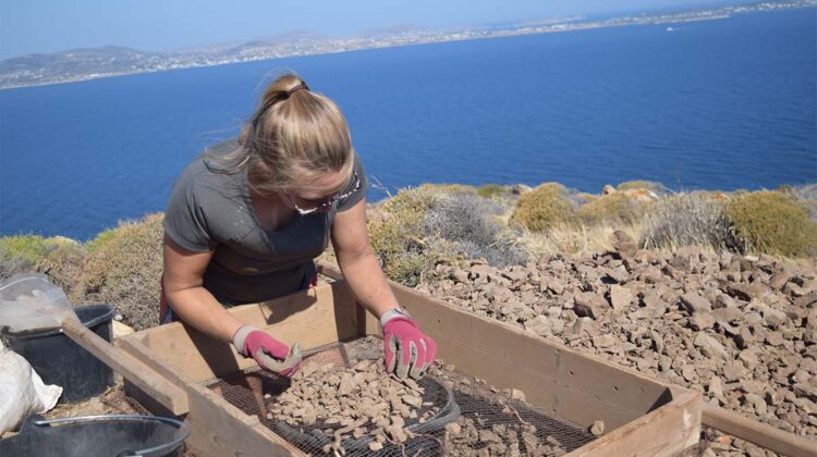 Photo of Kristin Harper sorting through soil on a top of a mountain (Photo Credit: Kristin Harper).